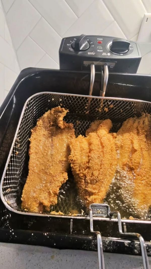 Cornmeal-crusted catfish frying in the basket