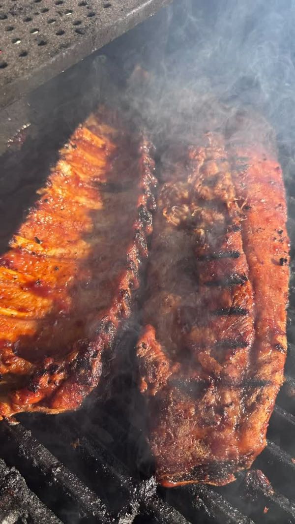 Racks of ribs smoking on the grill